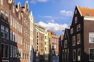 Amsterdam Prints: Houses in Amsterdam catch the warm light of sunset over North Holland skies in Western Europe
