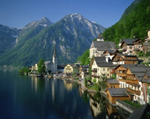 Houses, chalets and the church of the village of Hallstatt beside the lake