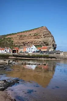 Staithes Prints: Houses nestled under the high cliffs in the small fishing village of Staithes