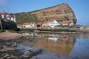 Staithes Prints: Houses nestled under the high cliffs in the small fishing village of Staithes