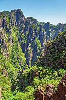 Geopark Prints: Huangshan Mountains show steep cliffs and green trees in a UNESCO site in Anhui Province