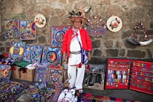 Huichol man selling Huichol handicrafts in the market, Patzcuaro, Michoacan state