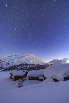 Excess Prints: The huts of Spluga covered in thick snow during a clear starry night