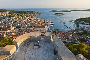 Hvar Island Prints: Hvar Town and tourists at Hvar Spanish Fort (Fortica) at sunset