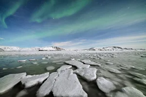 Arctic Gallery: Ice blocks in the frozen Arctic sea lit by Northern Lights (Aurora Borealis)