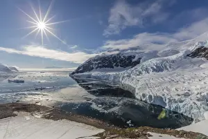 Ice choked waters surrounded by ice-capped mountains and glaciers in Neko Harbor