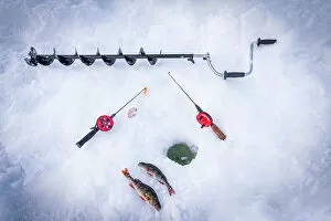 What's New: Ice drill, fishing rods and catch of fish close to ice hole, Lapland, Sweden, Scandinavia, Europe