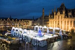Ice Rink and Christmas Market in the Market Square, Bruges, West Vlaanderen (Flanders), Belgium, Europe
