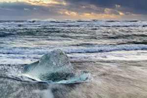 Lagoon Gallery: Iceberg from melting glacier on black sand beach near Jokulsarlon glacier lagoon