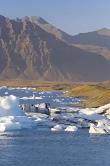 Southern Area Prints: Icebergs floating in the Lagoon beneath Breidamerkurjokull Glacier
