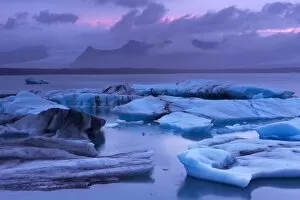 Images Dated 24th September 2008: Icebergs in Jokulsarlon glacial lagoon, at dusk, Oraefajokull (Vatnajokull) glacier in the distance