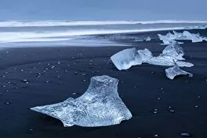 Lagoon Gallery: Icebergs from melting glacier on black sand beach near Jokulsarlon glacier lagoon