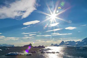 Antarctic Prints: Icebergs and mountains in Paradise Bay under sunlight in Antarctica