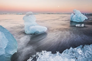 Volcanic Sand Prints: Icebergs at sunset on Jokulsarlon Beach, a black volcanic sand beach in South East Iceland