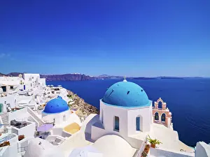 Iconic blue domed churches of Resurrection of the Lord and Saint Spyridon, Oia Village, Santorini (Thira) Island, Cyclades, Greek Islands, Greece, Europe
