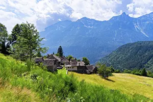 Piedmont Prints: Idyllic alpine village on a green slope with an mountainous background