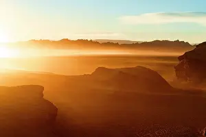 Idyllic sunrise over volcanic rock formations and mountains in the surreal Labyrinth Desert, Puna, Argentina