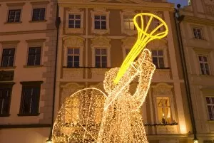 Illuminated angel against Baroque house facades, part of Christmas decorations