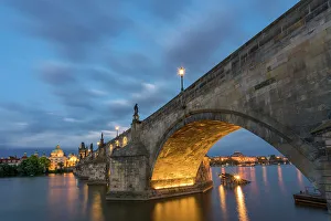 Vltava Prints: Illuminated arch of Charles Bridge at twilight