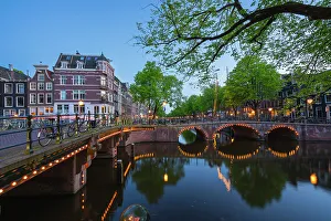 Amsterdam Prints: Illuminated bridge over Brouwersgracht canal at twilight