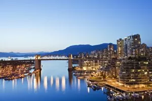 Illuminated buildings in Fals e Creek Harbour, Vancouver, Britis h Columbia