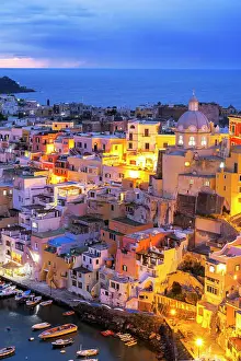 Naples Bay Prints: Illuminated fishing village of Marina Corricella at dusk