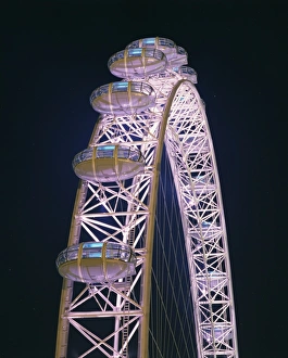 Illuminated by moving coloured lights, London Eye, architects Marks Barfield