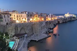 Apulia Prints: Illuminated pool of luxury resort by the sea at dusk in Vieste old town, Foggia province