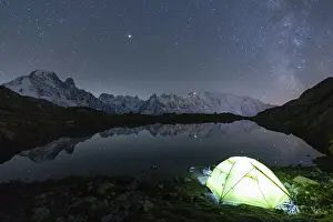 Spiral Galaxy Prints: Illuminated tent under the stars at Lacs des Cheserys with Mont Blanc massif reflected in
