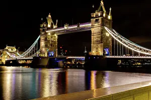Famous Landmarks Prints: Illuminated Tower Bridge in London at night with reflections on the River Thames