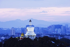 Images Dated 23rd August 2008: An illuminated White Pagoda and city buildings at sunset, Beihai park, Beijing