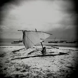 Monochrome Gallery: Image taken with a Holga medium format 120 film toy camera of dhow on beach in stormy weather