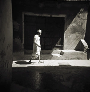 Monochrome Gallery: Image taken with a Holga medium format 120 film toy camera of a man in white djellaba caught in