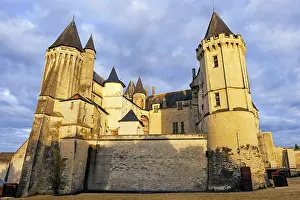 Chateau Prints: Impressive architecture of Chateau de Saumur with towers and clouds in the sky during late afternoon in Maine-et-Loire