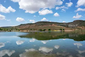 Mirror Prints: Impressive landscape of Akkoy dam lake with clear reflection of hills and clouds in Cappadocia Turkey