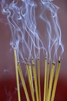 Foreground Focus Gallery: Incense sticks on joss stick pot burning, smoke used to pay respect to the Buddha