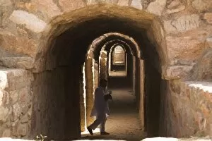 An Indian man visits the dungeons of Tughluqabad Fortress, constructed under Ghiyas-ud-Din in 1321 AD