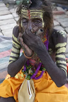 Indigenous Culture Prints: Indian sadhu smoking a chilum in Vrindavan, Uttar Pradesh, India, Asia