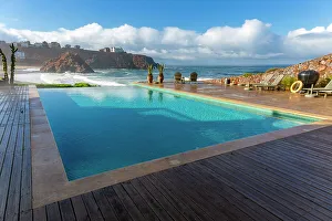 Lounge Chairs Prints: Infinity swimming pool overlooking Atlantic Ocean