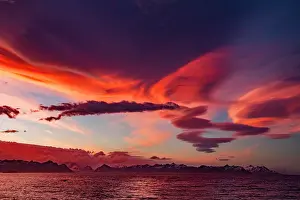 Conditions Prints: Interesting lenticular cloud formations forming over the island of South Georgia at sunset in the Southern Ocean