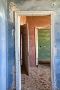 Luderitz Prints: Interior of building slowly being consumed by the sands of the Namib Desert in the abandoned former German diamond