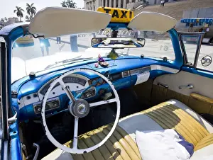 Restored Prints: Interior of old American car being used as a taxi showing blue dashboard