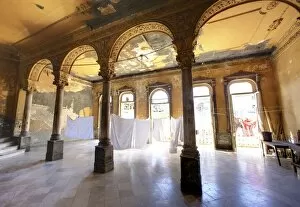 Interior of a once ornate and grand apartment building, now in a state of disrepair
