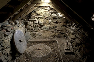 Shetland Prints: Interior of a restored old click mill alongside a small burn