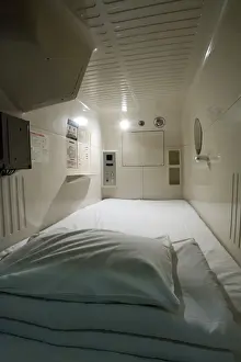 Bed Room Prints: Interior view of single-person sleeping compartment at capsule hotel in Osaka