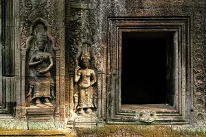 Southeast Prints: Intricate carvings on walls of Ta Prohm Temple showcase ancient artistry in Cambodia's historical site near Siem