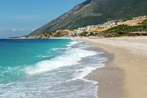 Albania Prints: Ionian Sea, Drymades Beach, with large scale tourist development construction building work in the distance