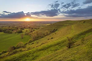 Solar Flare Prints: Iron-age hillfort of Hambledon Hill at sunset, Cranborne Chase AONB
