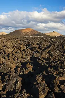 Arid Landscapes Prints: Irregular blocky lava (a a) and cinder cones of the volcanic landscape of Timanfaya National Park