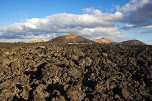 Irregular blocky lava (Hawaiian term: a a) and cinder cones of the volcanic landscape of Timanfaya National Park